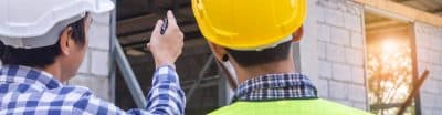 Two engineers inspecting a building